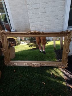 Mirror with gold plastic frame