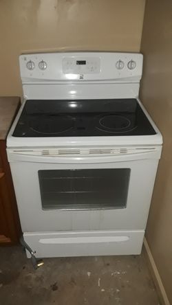 Kenmore electric stove and brand new garbage disposal unit.