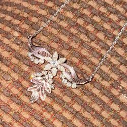 vintage rhinestone crystal brooch with a winged leafy flower design