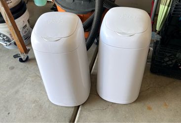 Two diaper genies with 4-6 refill bags