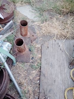 Two metal post holders. With 2 holes in the side