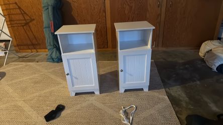 Two matching white wooden nightstands