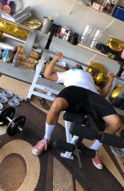 Body solid bench, leg extension, squat rack, barbell with 2 - 35lbs plates