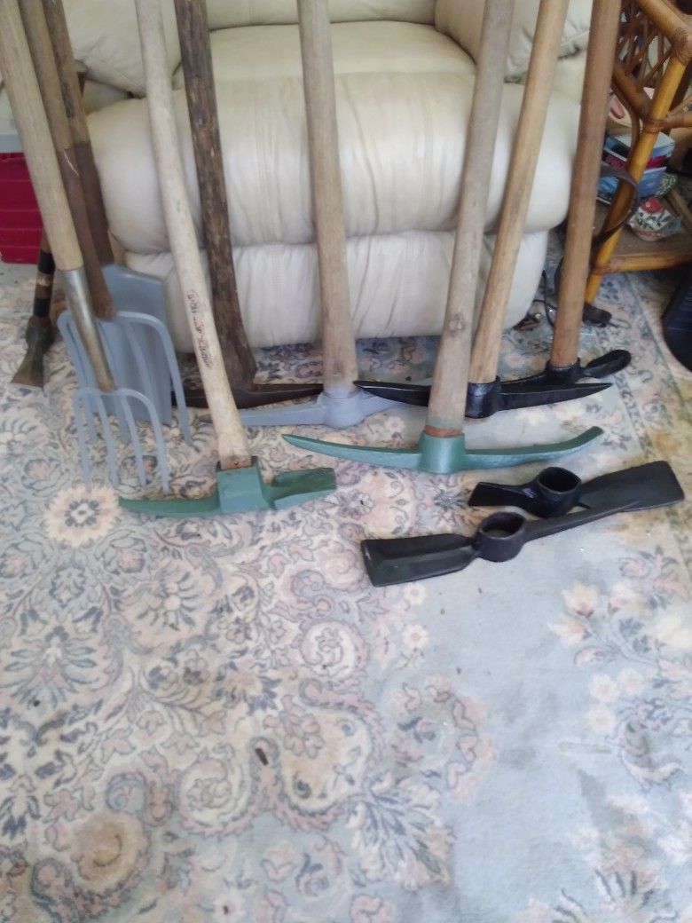 4 PICK AXES   1 MADAXE. 2 MADAXE HEADS  2 CAULTIVATERS. 1 SQ SHOVEL 2 SMALL MADAXES.  