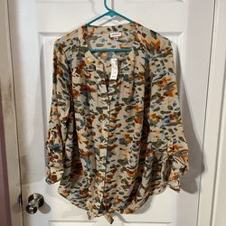 Brand new with tags Women’s Size 14 / 16 long sleeve roll tab sleeves top.  Vneck with button down front.  Made of 100% Polyester.  Brand new with tag