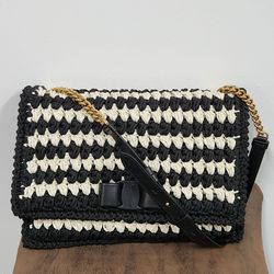 Ferragamo black and white handwoven shoulder bag with gold chain strap and signature bow detail