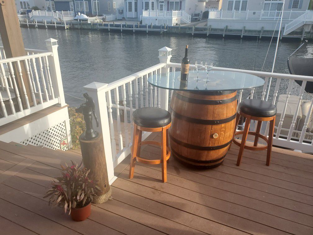 Bistro set: glass top wine barrel table and two stools. Nautical decor furniture beach dock