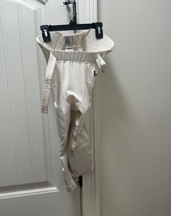 TWO pairs of Adidas padded football white size small used 3 times.