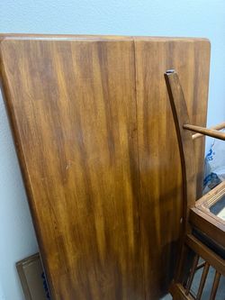 Sturdy wood table with built in leaf and four chairs