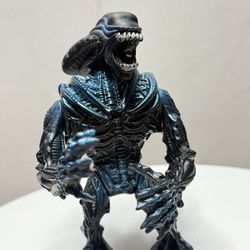 A vintage Gorilla Alien action figure from the *Aliens* toy line, released by Kenner in 1992.  The Grab": When the mechanism is pressed, the figure's 