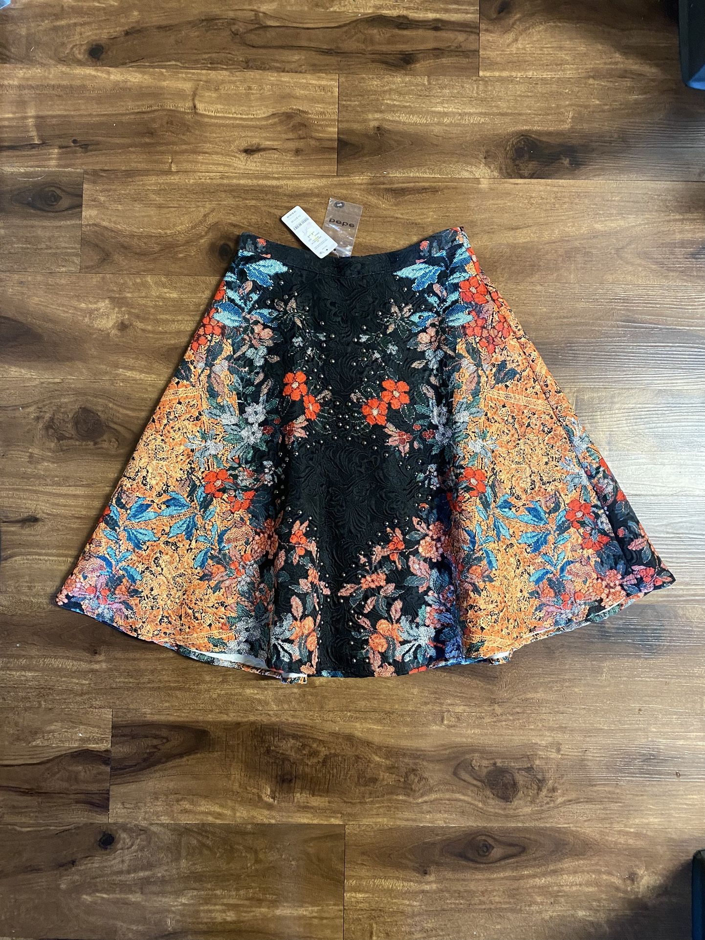 Brand new woman’s Bebe brand “Tall Tail” Floral skirt up for sale