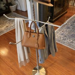 Mid century modern chrome coat rack with a sleek atomic design. Approximately 45 inches tall, very sturdy.  Features rotating arms that can be adjuste