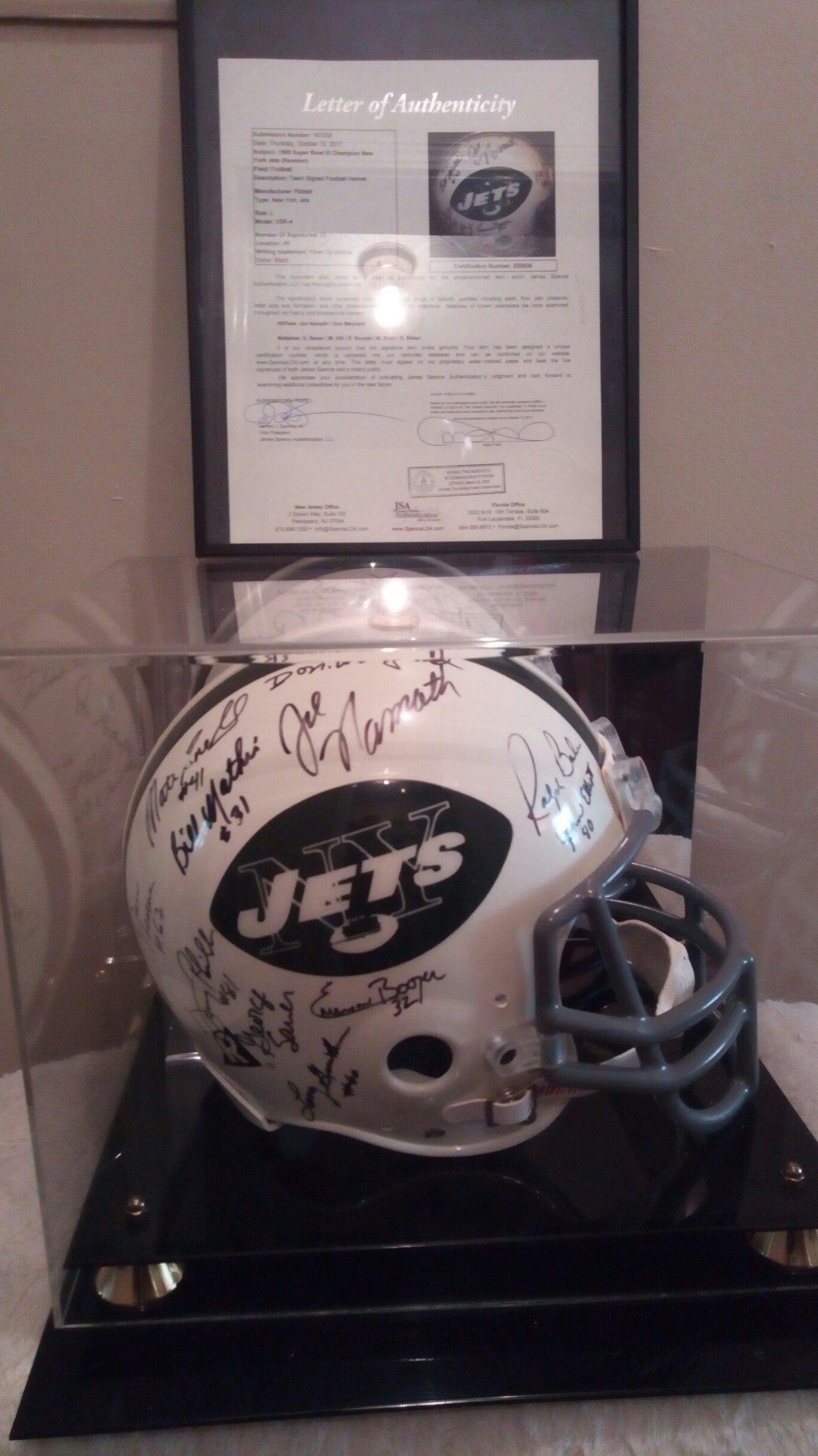 Extremely rare Joe Namath team sighed period correct riddle helmet in mirrored display case with JSA letter of authenticity