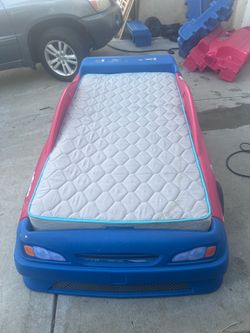 Two race car beds with mattresses