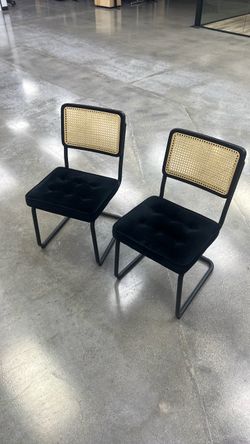 (Used) Crumley/Marlow-style cantilever dining chair with black velvet tufted seat, natural cane/rattan back, and black tubular steel frame