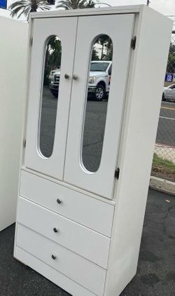 Tall white closet with mirrors