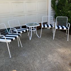 Set Of Four stackable White Metal Chairs, New Black And White Cushions And Glass Top Side Table 