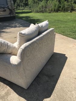 Upholstered beige loveseat