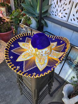 Traditional purple velvet charro hat adorned with embroidery and gold metallic details.