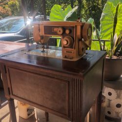 Antique Sewing Machine In Cabinet