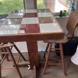 Ceramic Table Top And High Wise Wooden Chairs.