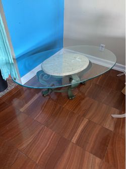 Coffee glass table with leaf motif/style. While marble base and light green feet decor