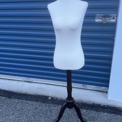 white female dress form mannequin torso with a dark wood tripod stand