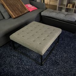 Fabric ottoman used as coffee table