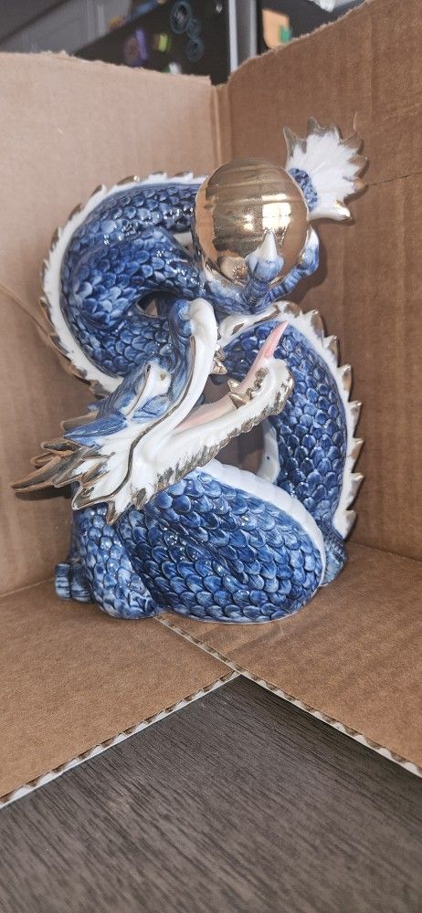 Porcelain Blue Dragon Figurine with Golden Orb Design