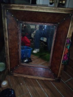 Beautiful mirror. Outer frame measures 27 1/4 X 33 X  3 1/2. The mirror has its own style frame and measures 15X22 and is braded wood. The frame is al