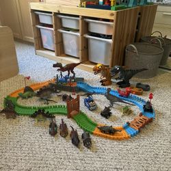 Dinosaur lot that includes remote controlled dinosaurs, track, plastic dinosaurs and Dino cars