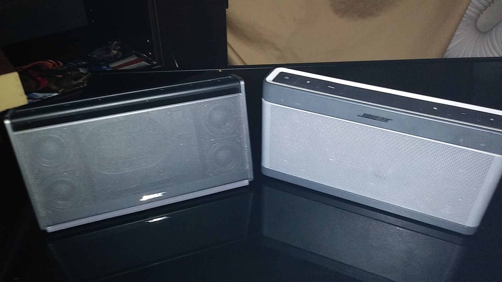 Two bose portable speakers with charger.