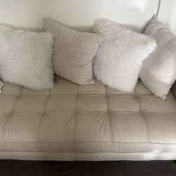 Small beige leather loveseat