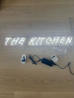Neon “THE KITCHEN” light.