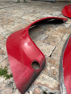 Four genuine Porsche 911 SC fender flare sections, approximately twelve to eighteen inches each,