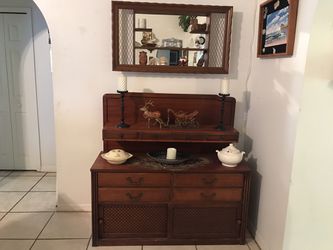 Old buffet with old mirror with small shelves