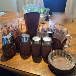This is a charming vintage glassware and barware set featuring a Western ranch theme.