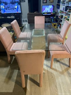 contemporary style glass dining table with 6 chairs.