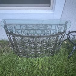 Glass Top Demilune Console With Scrolling Metal Base and Wine Rack