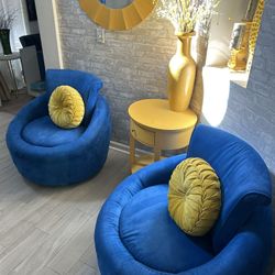 Two round royal blue swivel chairs