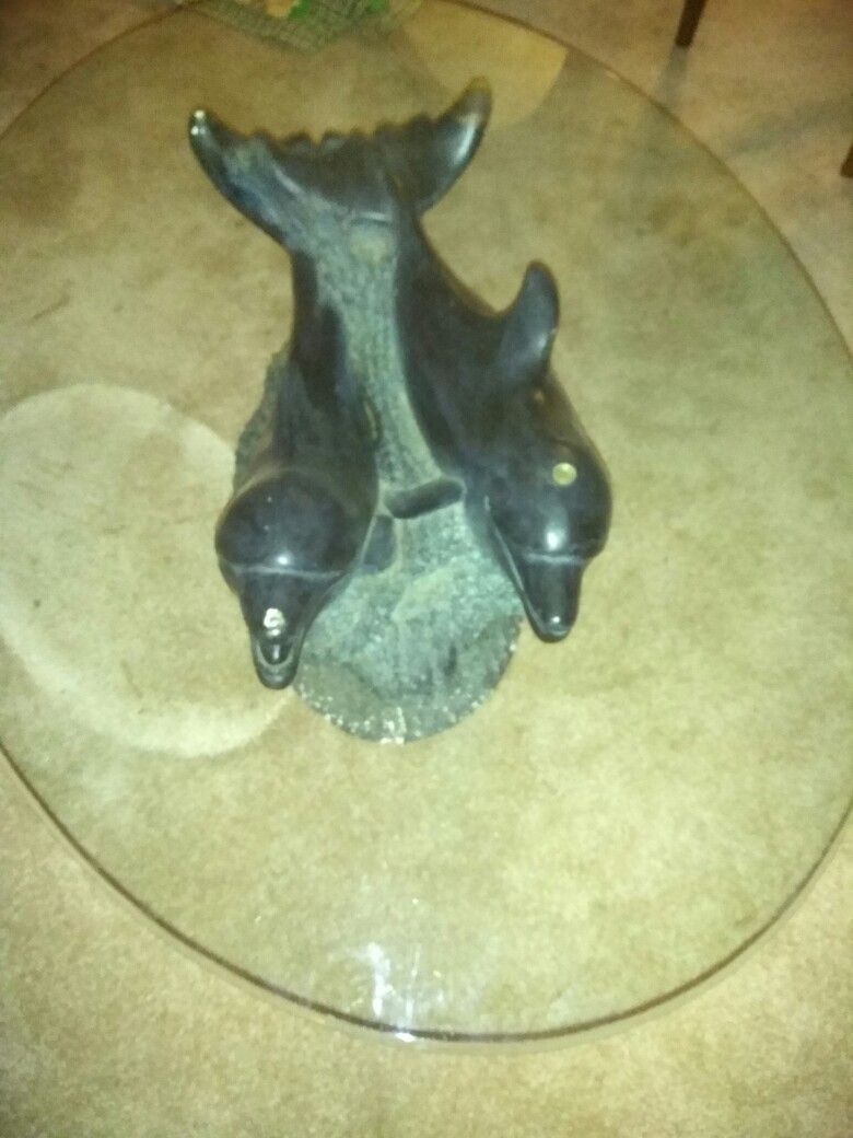 Free glass table with dolphin base