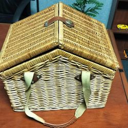 Picnic time large wicker picnic basket with plates, cups, full silverware, napkins, and various utensils