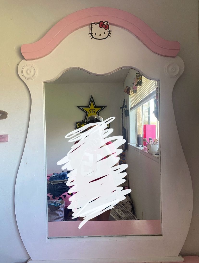 pink and white dresser with mirror and side table
