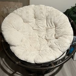 Dark wood papasan with white pillow