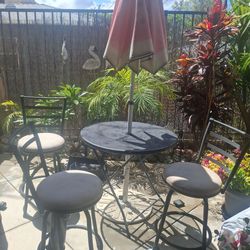 High bar chairs(3) and table for patio. Umbrella and the holder of umbrella .