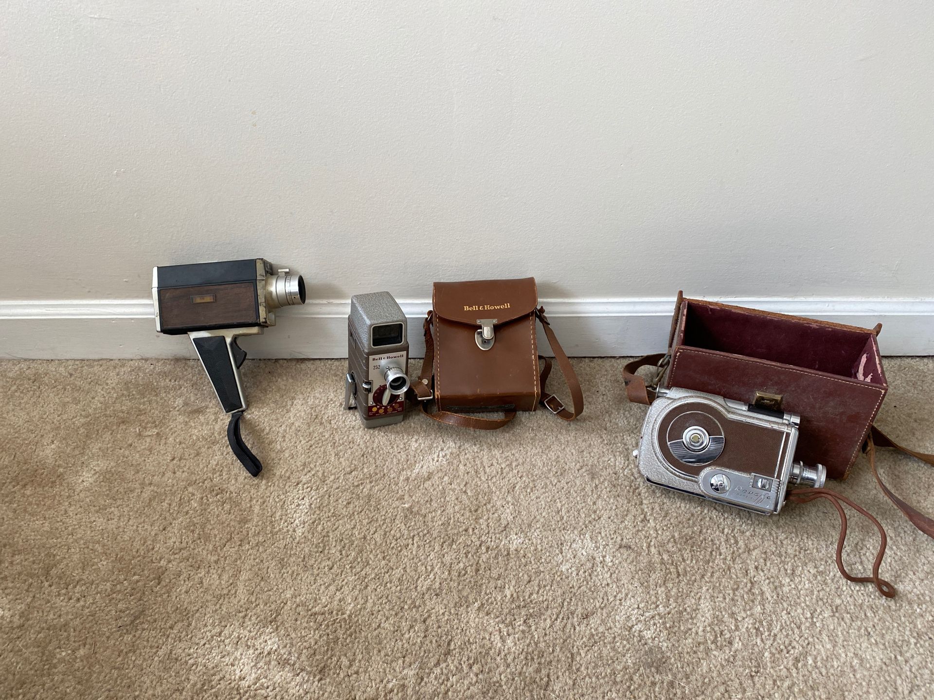 Three Bell and Howell vintage movie cameras