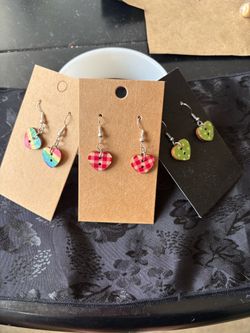 Three pairs of heart-shaped wooden earrings