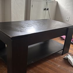 Coffee table with built in storage compartment