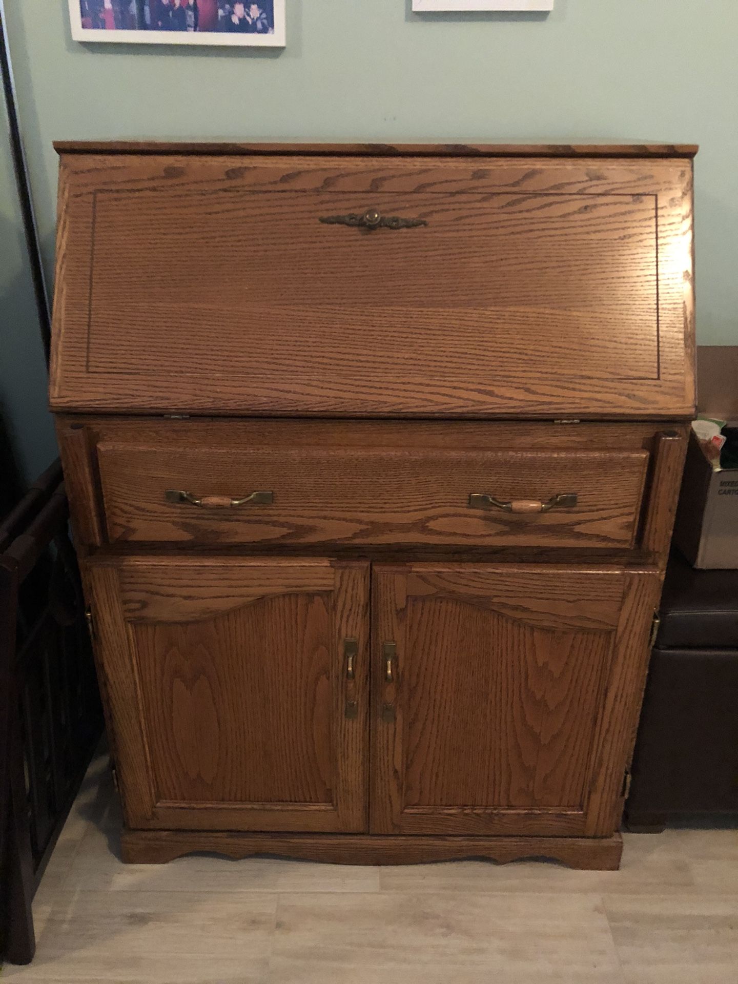 Solid oak desk for sale, 43” high, 32” wide & 19”deep. The top folds up to conceal the inside of the desk large drawer and two doors on the bottom.