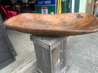 Antique hand made wooden bowl. Oval in shape. Looks to be very old, possibly turn-of-the-century European based printing on the metal used to repair t
